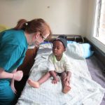medical volunteer talking to child
